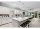Bright, modern kitchen with a large island, white cabinetry, and stainless steel appliances at 121 Colebrook Ct, Venice, FL 34292