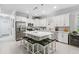 Stunning kitchen with a large island, white cabinetry, stainless steel appliances, and ample counter space at 121 Colebrook Ct, Venice, FL 34292