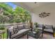 Inviting covered patio is furnished with plush seating and lush views at 121 Colebrook Ct, Venice, FL 34292