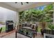 Enjoy the outdoor views from this cozy covered patio with comfortable seating and grill at 121 Colebrook Ct, Venice, FL 34292