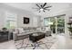Comfortable living room featuring a large sectional sofa, modern ceiling fan, and a view of the outdoor patio at 121 Colebrook Ct, Venice, FL 34292
