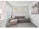 Bright living room featuring a grey sectional sofa, plantation shutters, and neutral decor at 121 Colebrook Ct, Venice, FL 34292