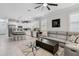 Open concept living room and kitchen area with bar stool seating and a comfortable sectional sofa at 121 Colebrook Ct, Venice, FL 34292