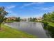 Scenic view of a community pond with fountain surrounded by well-maintained landscaping and neighborhood homes at 121 Colebrook Ct, Venice, FL 34292