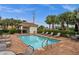 Community pool with tables and lounge chairs with lush tropical landscaping offering privacy at 121 Colebrook Ct, Venice, FL 34292