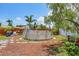Backyard featuring above ground pool, charming patio area, privacy fence, and mature trees at 1222 Pinebrook Way, Venice, FL 34285