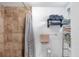 Cozy bathroom with tiled shower, towel rack, and built-in shelving for storage at 1222 Pinebrook Way, Venice, FL 34285