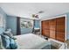 Charming bedroom with a ceiling fan, closet with louvered doors, and natural light at 1222 Pinebrook Way, Venice, FL 34285