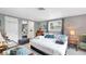 Serene bedroom featuring a comfortable bed, soft lighting, and a glimpse into the bathroom at 1222 Pinebrook Way, Venice, FL 34285