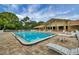 Well-maintained community pool and recreation area with tables and chairs at 1222 Pinebrook Way, Venice, FL 34285