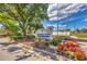 Entrance to Pinebrook South, a deed-restricted community featuring lush landscaping and colorful flowers at 1222 Pinebrook Way, Venice, FL 34285