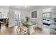 Bright dining room adjacent to a living room and bedroom with a glass top table at 1222 Pinebrook Way, Venice, FL 34285