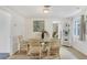 Bright dining room featuring a glass top table and wicker chairs at 1222 Pinebrook Way, Venice, FL 34285