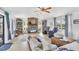 Bright living room features large windows, a brick fireplace, and comfortable seating arrangements at 1222 Pinebrook Way, Venice, FL 34285