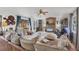 Comfortable living room featuring a brick fireplace, ceiling fan, and ample seating at 1222 Pinebrook Way, Venice, FL 34285