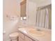 Bright bathroom featuring a vanity with a sink, toilet, and a window with a bamboo shade at 1290 Leeward Rd, Venice, FL 34293