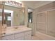 Bathroom featuring a vanity with drawers and cabinets, a shower and a light green wall at 1290 Leeward Rd, Venice, FL 34293