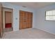 Cozy bedroom featuring plush carpeting, spacious closet, and natural light from a window, creating a comfortable space at 1290 Leeward Rd, Venice, FL 34293