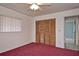 Another bedroom with plush carpeting, ceiling fan, a window and closet with sliding doors at 1290 Leeward Rd, Venice, FL 34293