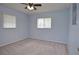 Comfortable bedroom with plush carpeting, large windows, and ceiling fan, offering a relaxing retreat at 1290 Leeward Rd, Venice, FL 34293