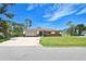 Well-maintained single-story home with lush landscaping and attached garage at 1290 Leeward Rd, Venice, FL 34293
