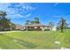 Charming single-story home featuring a well-manicured lawn and an inviting front yard with mature trees at 1290 Leeward Rd, Venice, FL 34293
