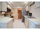 Well-maintained kitchen with stainless steel appliances, tiled floor, ample cabinet space, and modern finishes at 1290 Leeward Rd, Venice, FL 34293