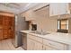 Traditional kitchen featuring stainless steel appliances and light wood cabinets at 1290 Leeward Rd, Venice, FL 34293
