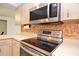 Well-equipped kitchen boasts stainless steel appliances, a smooth cooktop and light-toned cabinetry at 1290 Leeward Rd, Venice, FL 34293
