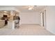 Spacious living room with open kitchen, tile floors, and sliding glass doors at 1290 Leeward Rd, Venice, FL 34293