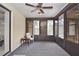 Screened-in patio with carpet, ceiling fan, and outdoor views at 1290 Leeward Rd, Venice, FL 34293