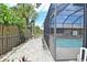 Screened-in pool with adjacent patio and landscaped walkway at 1290 Leeward Rd, Venice, FL 34293