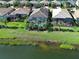 Aerial view of homes with screened-in lanais, pools, lush landscaping, and lake views, showcasing a vibrant community at 13862 Miranese St, Venice, FL 34293