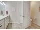 Well-lit bathroom with a vanity, artwork, a closed toilet, and tile flooring at 13862 Miranese St, Venice, FL 34293