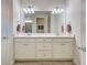 Bright bathroom with double vanity, ample storage, and modern fixtures with tile flooring at 13862 Miranese St, Venice, FL 34293