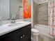 Modern bathroom featuring a shower, bathtub, vanity, and stylish flamingo-themed decor at 13862 Miranese St, Venice, FL 34293