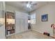 Cozy bedroom featuring a built-in Murphy bed, shelving, a shuttered window, and tile floors at 13862 Miranese St, Venice, FL 34293