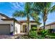 Charming single-story home with lush tropical landscaping and a brick-paved driveway at 13862 Miranese St, Venice, FL 34293