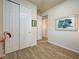 Hallway boasts double closets, ceramic tile floors, light paint, and coastal decor at 13862 Miranese St, Venice, FL 34293