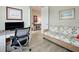 Home office features a wicker couch with flamingo print, computer desk, and views to another room at 13862 Miranese St, Venice, FL 34293