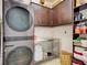 Efficient laundry room with modern appliances, ample storage, and functional workspace at 13862 Miranese St, Venice, FL 34293
