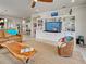 Cozy living room featuring a wooden coffee table, a large entertainment center, and comfortable seating at 13862 Miranese St, Venice, FL 34293