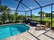 Inviting screened-in pool area with lounge chairs and a serene lake view at 13862 Miranese St, Venice, FL 34293
