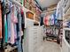 Spacious walk-in closet featuring built-in shelving, drawers, and ample storage for clothes and accessories at 13862 Miranese St, Venice, FL 34293
