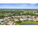 An aerial view of a neighborhood with well-maintained homes and lush landscaping, located near a school at 2396 Caraway Dr, Venice, FL 34292
