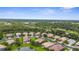 A high-angle shot of lovely homes surrounded by mature trees and bodies of water, nestled in a community at 2396 Caraway Dr, Venice, FL 34292