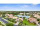 Aerial view of the neighborhood, highlighting the community's serene lake and lush landscaping at 2396 Caraway Dr, Venice, FL 34292