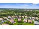 This aerial showcases a tranquil community with pond views and lush greenery surrounding beautiful single-Gathering homes at 2396 Caraway Dr, Venice, FL 34292