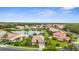 Community aerial view with pond and mature trees at 2396 Caraway Dr, Venice, FL 34292