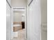 Bright bathroom featuring a soaking tub with tiled surround, dark wood cabinets, and tile flooring at 2396 Caraway Dr, Venice, FL 34292